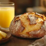 Artisan bread with pineapple juice and fresh pineapple slices on a rustic wooden table.